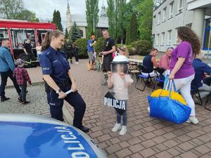 policjantka na zdjęciu z uczestnikami pikniku.