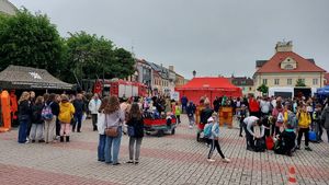 Stoiska promocyjne służb i uczestnicy wydarzenia pomiędzy nimi na placu Tadeusza Kościuszki.
