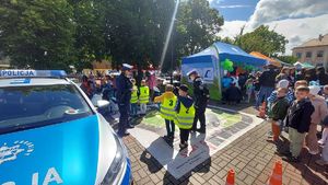 Policjanci, radiowóz i gra edukacyjna z dziećmi na palcu Kościuszki w Łęczycy.